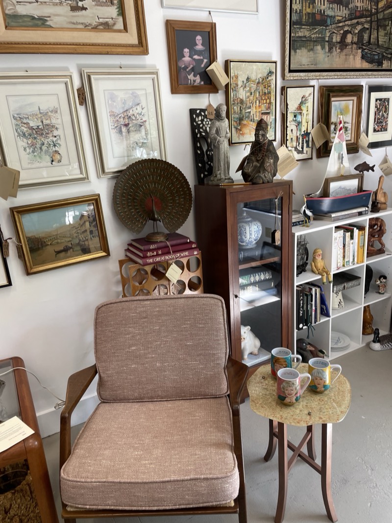 Inside the shop, shelves and walls filled with curated antiques and art